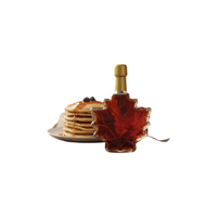 Doodle's Sugarbush, LLC pure Michigan maple syrup in a decorative maple leaf glass bottle on a breakfast table
